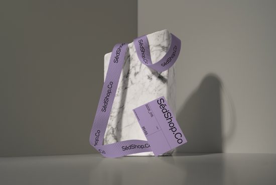 Marble textured packaging box with purple branded ribbon on a shadowy background, perfect for product mockups, packaging design, branding.